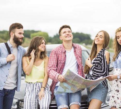 group-young-friends-standing-front-car-outdoors